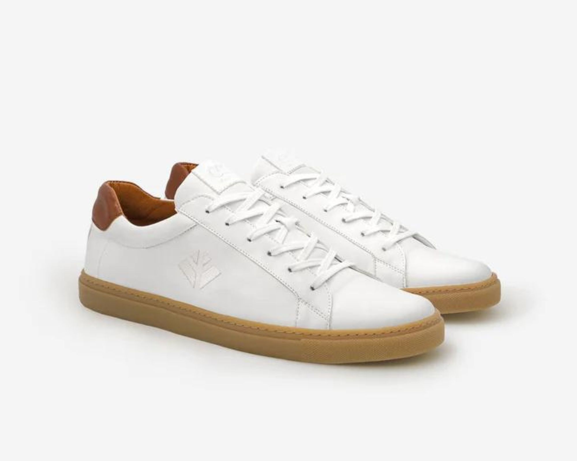 A pair of white sneakers with a gum sole like Adidas Sambas, made responsibly by COG.