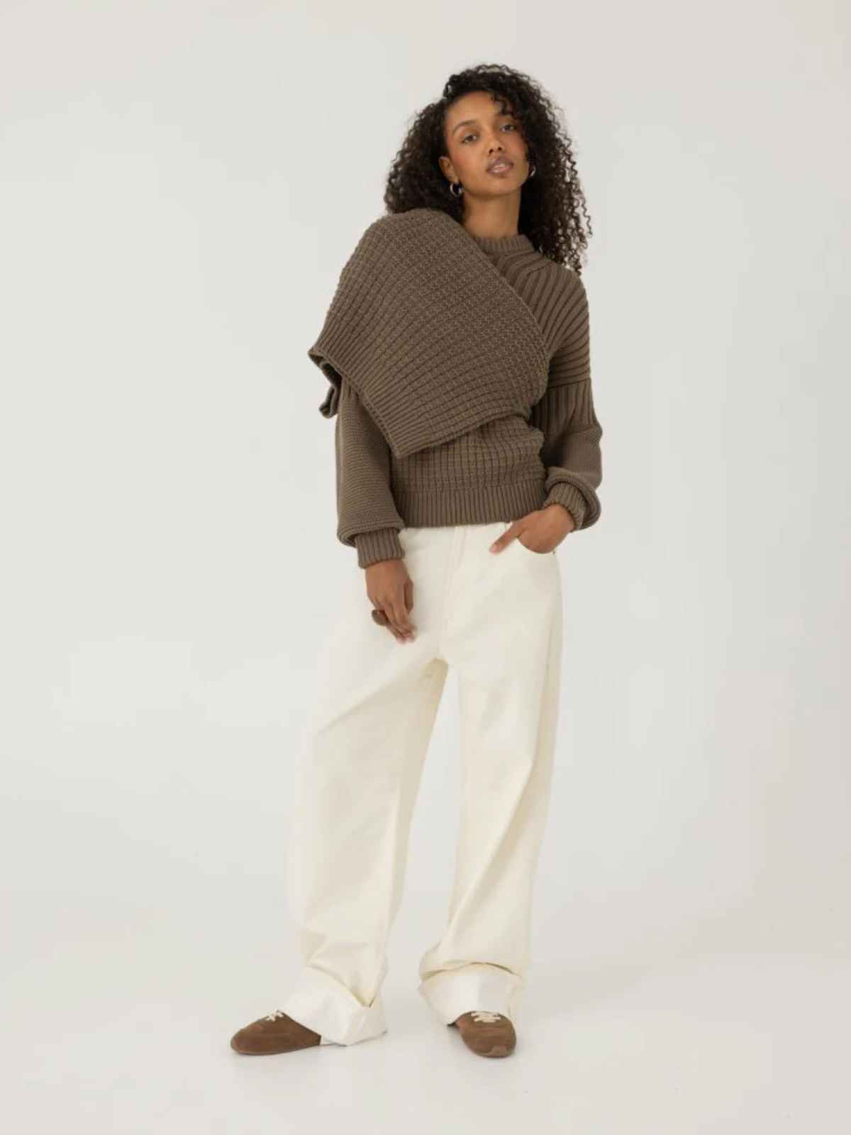 person wearing chunky knit sweater from more sustainable brand the knotty ones