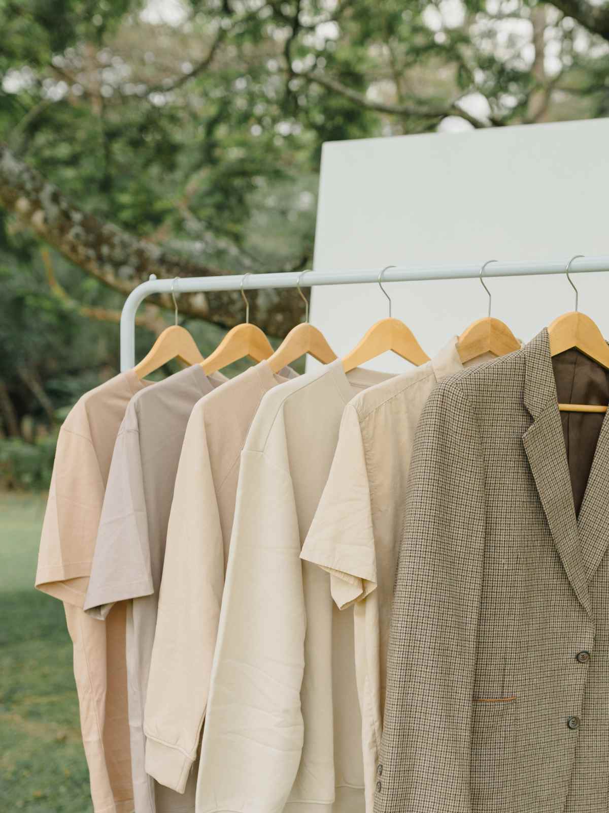 clothing rack featuring beige items and checked blazer