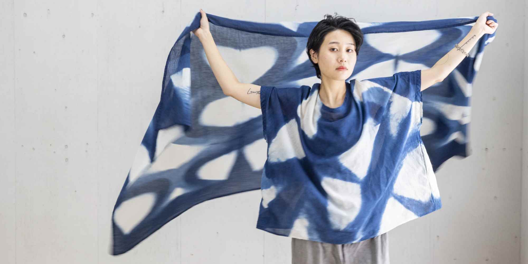 Person wearing hand-dyed clothing with scarf