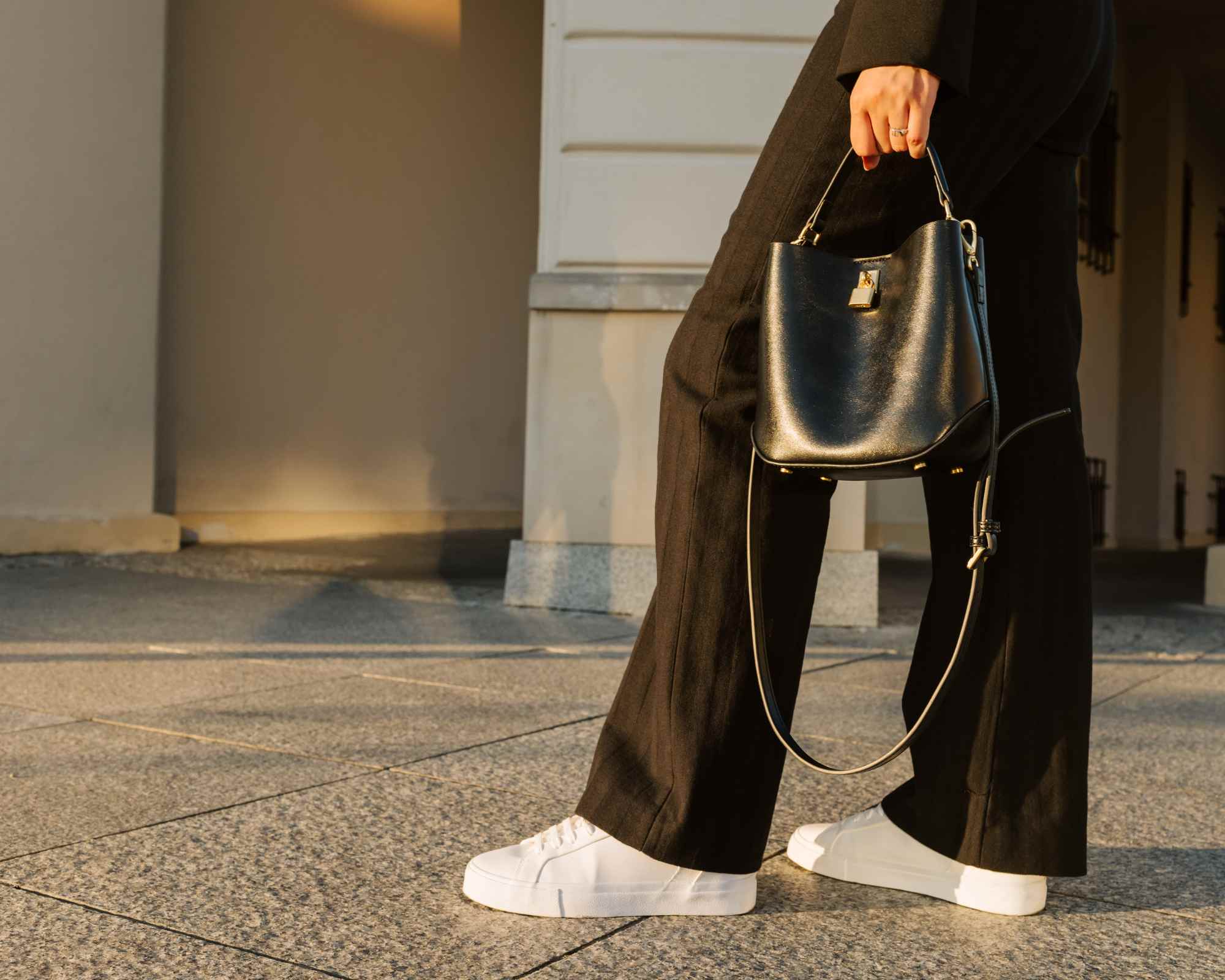 person holding black handbag