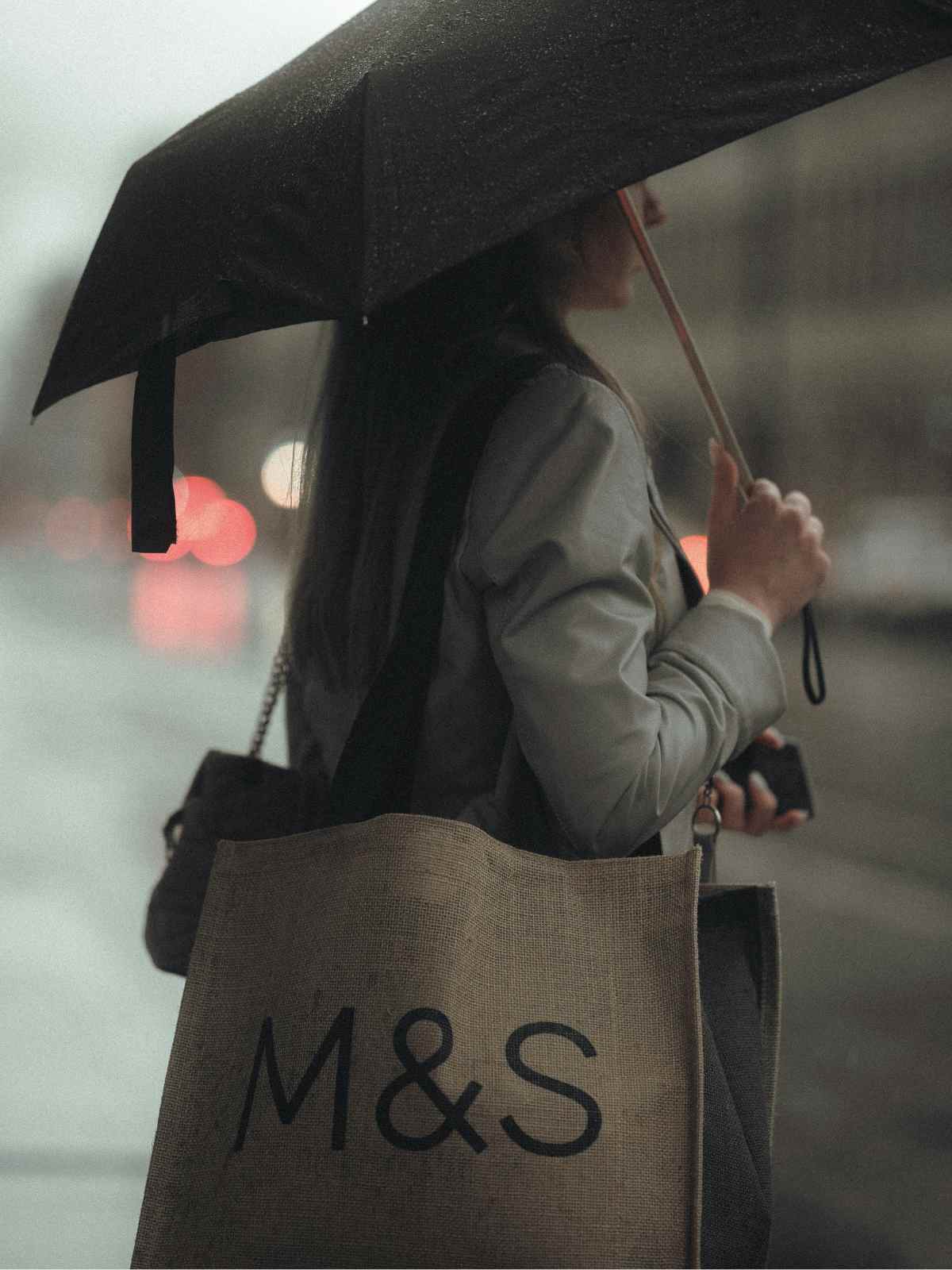 person carrying m&s bag